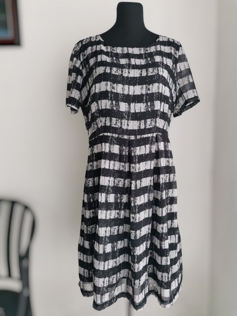 Monochrome Horizontal Stripe Dress (Large) (Category: Dresses) located in Quezon City. Submitted by engeleaize (Listing ID 1464834277, Image 1). Description: Details: Color: Black and Off-White Style: Lightweight silhouette dress, scoop neckline, sheer short sleeves, distressed brushstroke patterns, side zipper, with inner lining Fabric: Chiffon Polyester Best worn: Smart casual wear, church services Bust: 38 inches Waist: 34 inches Length: 38 in