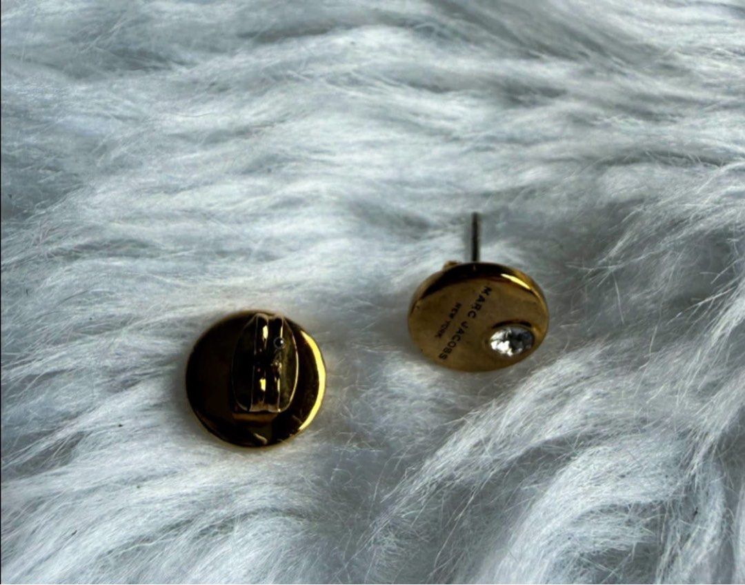M@rc Jac0bs Stud Earrings (Category: Earrings) located in Manila. Submitted by annafinds (Listing ID 1464868036, Image 2). Description: A pair of gold-tone M@rc Jac0bs Stud Earrings with crystal accents, presented in their original box. - In excellent condition ₱3,999 Open for layaway. Disclaimer: We are not affiliated, associated, authorized, endorsed by or in any way officially connected with any other company or luxury brand. All copyrights ar