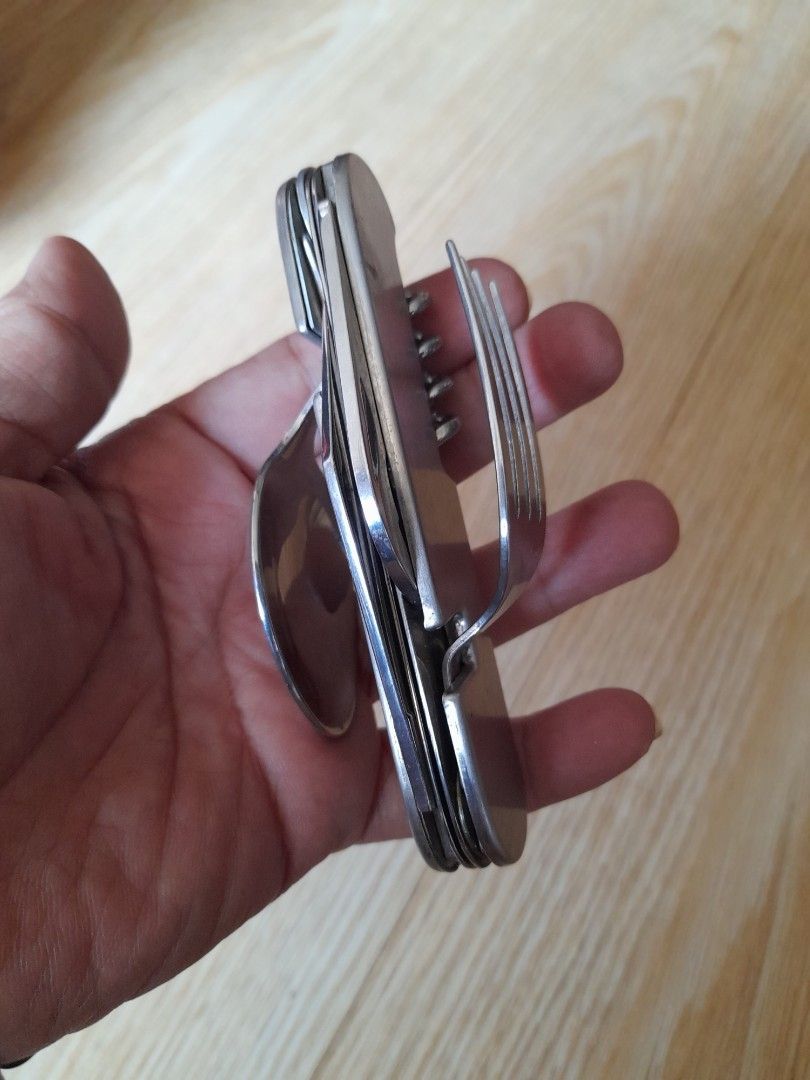 Multifunction Camping Cutlery Knife Fork Spoon Bottle Opener (Category: Hiking & Camping) located in Bocaue. Submitted by marajapansurplus (Listing ID 1464811341, Image 1). Description: - All-in-one outdoor tool: Combines fork, spoon, pocket knife, corkscrew, bottle opener, and awl - Dual-piece design: Splits apart so you can use the fork and knife at the same time - Built to last: Made of durable, rust-resistant stainless steel with sturdy metal