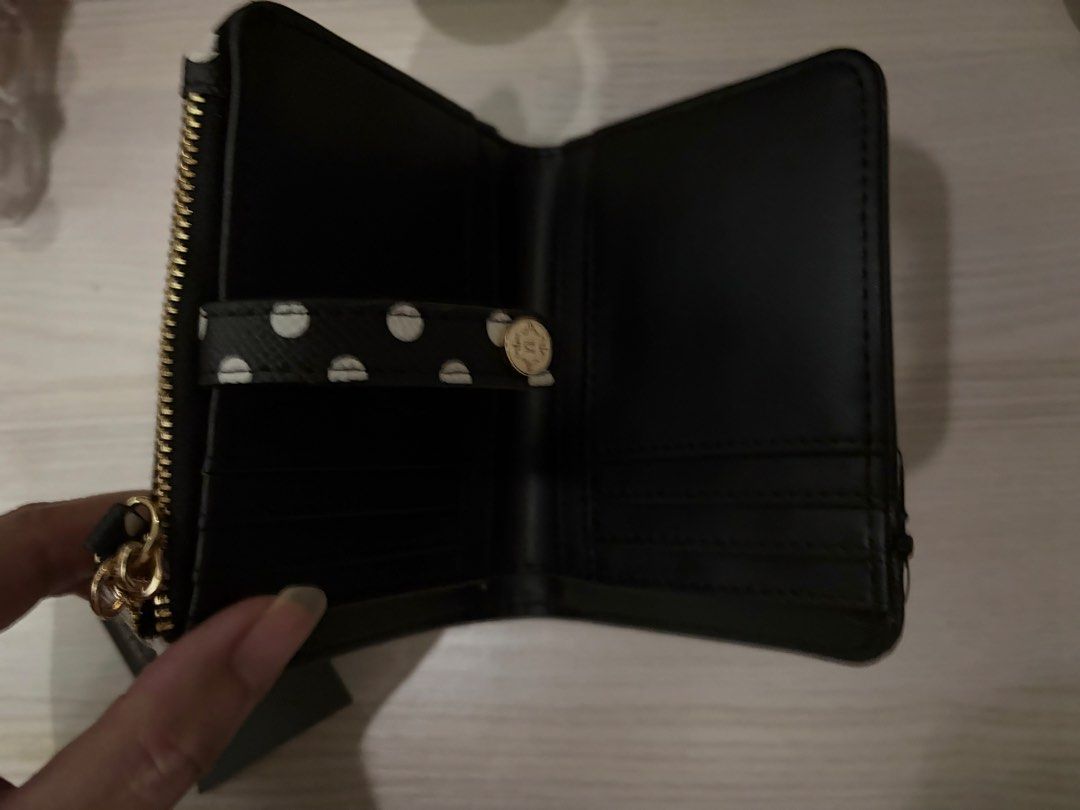 Nanette Lepore Black White Polka Dot Wallet (Category: Wallets & Card holders) located in Manila. Submitted by sc.moo04 (Listing ID 1464945038, Image 2). Description: - Brand: Nanette Lepore - Pattern: Black and white polka dot - Hardware: Gold - Closure: Snap strap - Interior: Multiple card slots - Coin Pouch: Attached zippered pouch with zipper pull - Condition: Brand new with tag attached, never used.
