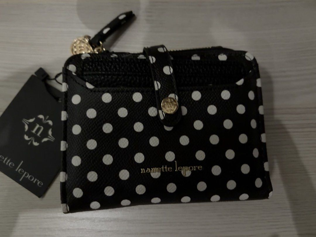 Nanette Lepore Black White Polka Dot Wallet (Category: Wallets & Card holders) located in Manila. Submitted by sc.moo04 (Listing ID 1464945038, Image 1). Description: - Brand: Nanette Lepore - Pattern: Black and white polka dot - Hardware: Gold - Closure: Snap strap - Interior: Multiple card slots - Coin Pouch: Attached zippered pouch with zipper pull - Condition: Brand new with tag attached, never used.