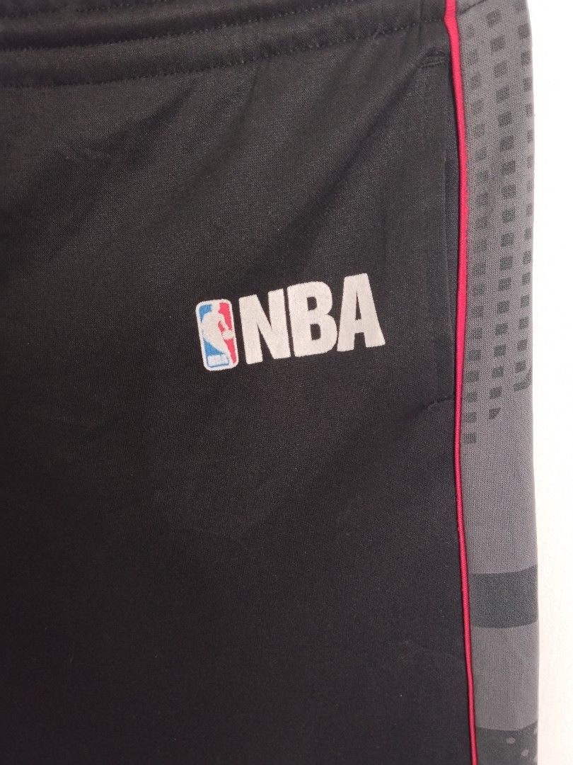 NBA Elevation Black Track Pants Size M (Category: Joggers) located in Bulacan. Submitted by waybak90s (Listing ID 1464776557, Image 2). Description: - Brand/Model: NBA Elevation Track Pants - Size: Medium (M) Dimes:W-30-34 L-34.5 - Color: Black with contrast grey side panels and red piping - Features: Adjustable drawstring waistband with NBA branding, subtle basketball graphic near hem, and white NBA logo on upper left leg - Fit: Relaxed fit - Co