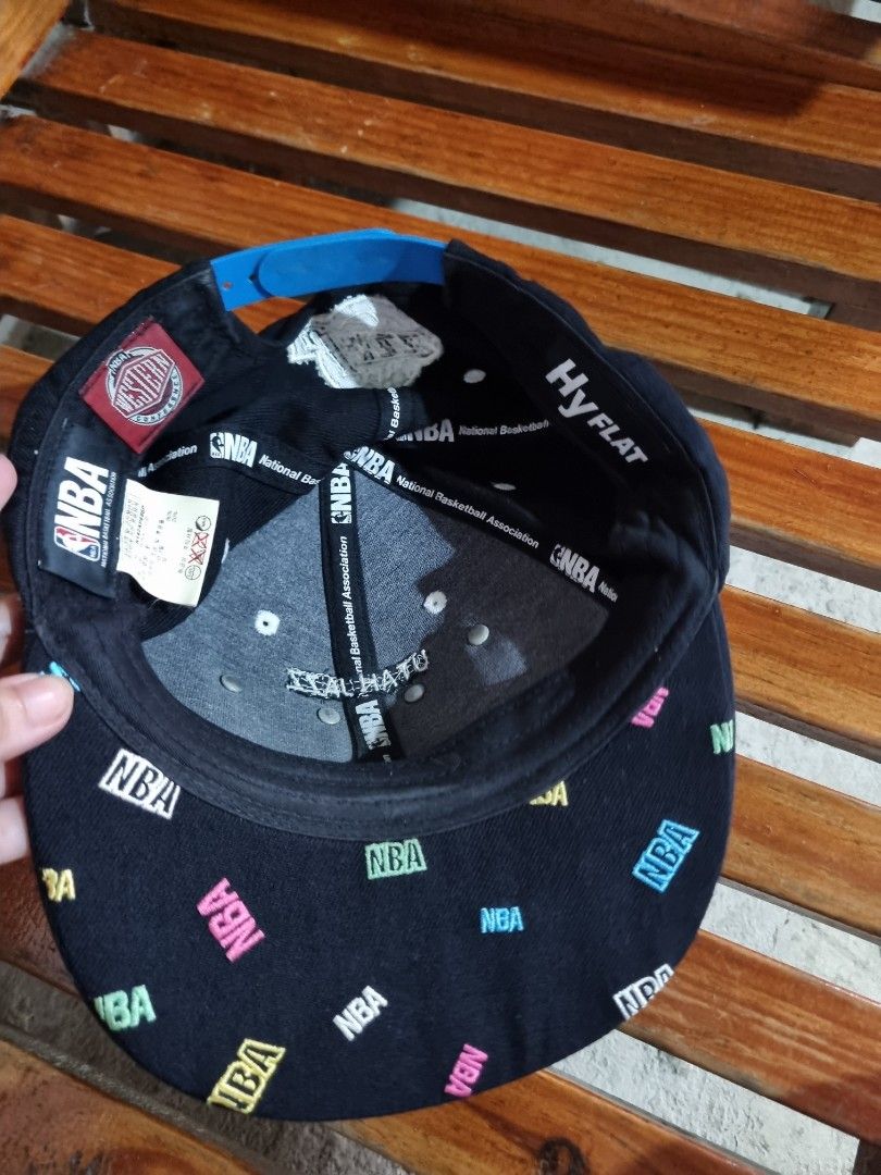NBA Utah Jazz SnapFit Snapback Cap (Category: Caps & Hats) located in Baguio. Submitted by phoeberose33384 (Listing ID 1464814065, Image 2). Description: - Authentic Utah Jazz snapback hat - Color: Black with vibrant, colorful raised letter detailing on the front - Adjustable blue snapback closure for a custom fit - Unique multi-colored NBA logos embroidered all over the underside of the brim - SnapFit HyFlat design - Interior branding tags fully