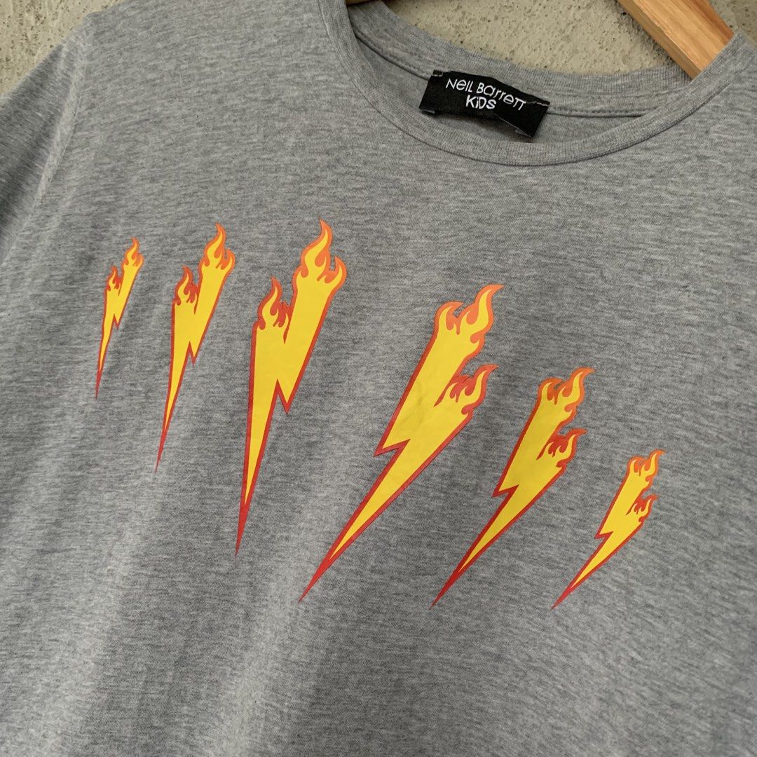 Neil Barrett Flame Lightning Bolt Baby Tee (Category: Shirts) located in Sindangan. Submitted by holy_thrift (Listing ID 1464829717, Image 2). Description: - Neil Barrett Flame Lightning Bolt Baby Tee - width / 18 - length / 24 - KIDS on tag fit sa S sa lalaki at S to M sa babae - no major issue sa 4th pic lang minimal crack sa back details - free shipping.