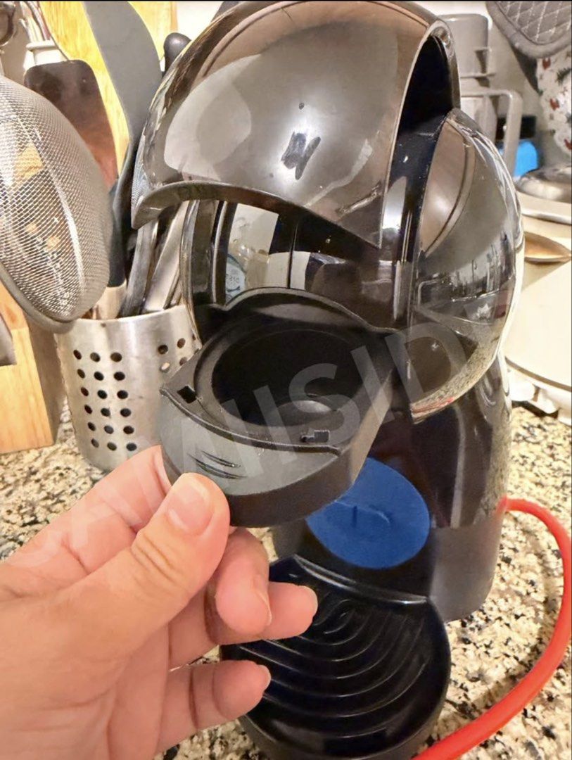 Nescafe Dolce Gusto Piccolo XS (Category: Coffee Machines & Makers) located in Las Pinas. Submitted by camiisidd (Listing ID 1464966170, Image 2). Description: - Model: Nescafé Dolce Gusto capsule coffee machine - Color: Sleek black with a vibrant red power cord - Design: Compact space-saving size, perfect for any kitchen countertop - Features: Simple blue button control, rear water tank, removable drip tray, and capsule holder - Function: Makes 