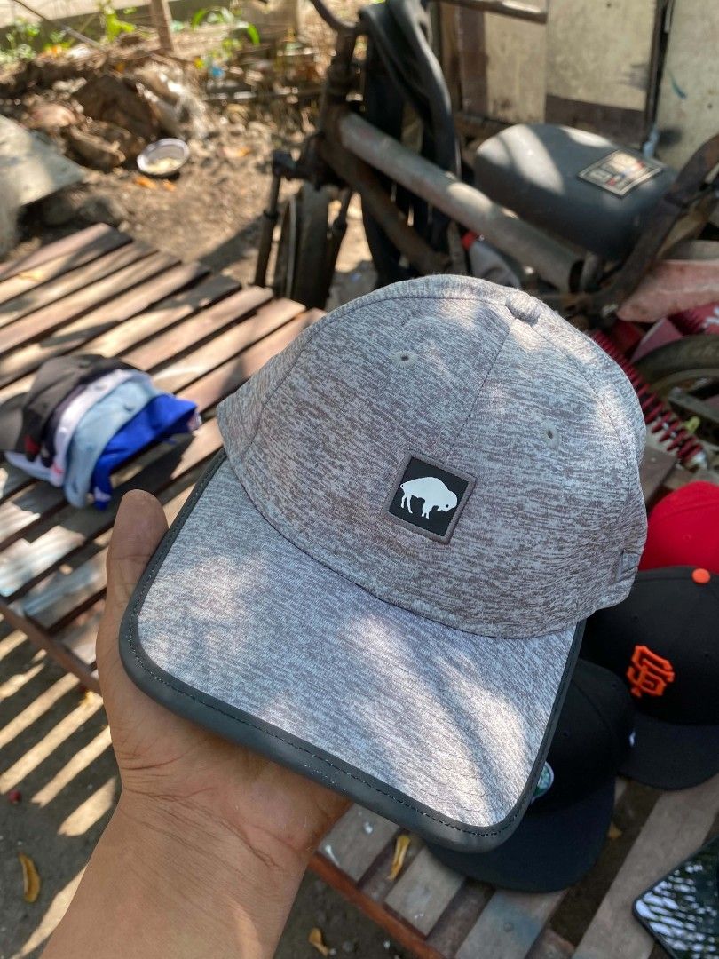 New Era 9Twenty One Buff Grey Cap (Category: Caps & Hats) located in Sibulan. Submitted by thethiftedcap0728 (Listing ID 1464887238, Image 1). Description: - Brand: New Era 9Twenty - Color: Grey heather textured with black strapback - Design: White buffalo logo patch on the front - Closure: Adjustable strap with plastic buckle - Authenticity: Official NFL tag sewn inside - Size: One size fits most.