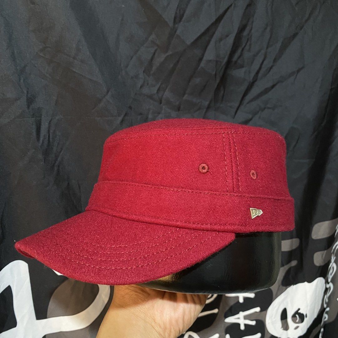 New Era Red Wool Cadet Cap Military Hat (Category: Caps & Hats) located in Villasis. Submitted by thriftngrind (Listing ID 1464910153, Image 1). Description: - Brand: New Era - Color: Deep burgundy red - Material: Solid wool - Style: Structured military-style cadet hat with a stiff brim - Details: Small silver metallic New Era flag logo pin and stitched eyelets for ventilation - Condition: Excellent, clean shape - Best for: Casual wear and colder