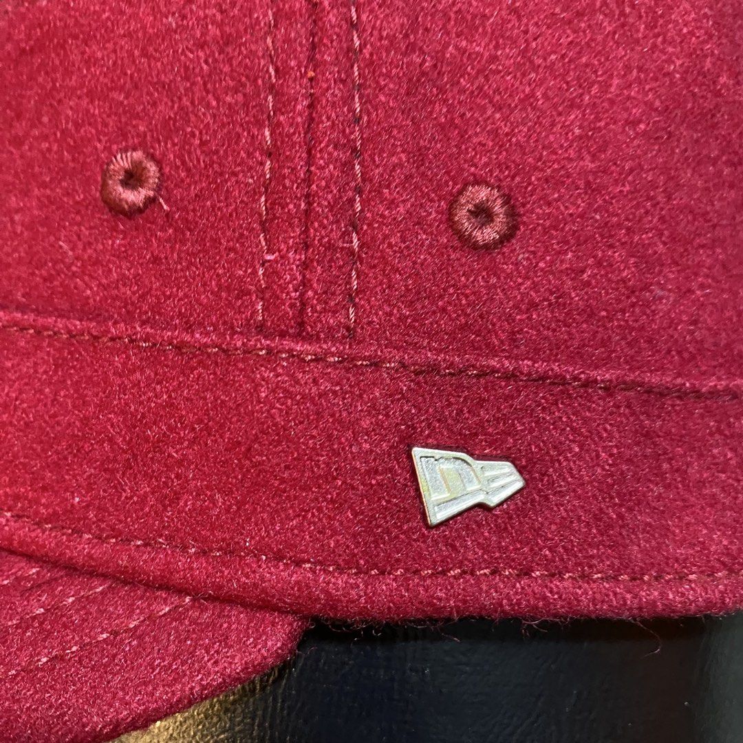 New Era Red Wool Cadet Cap Military Hat (Category: Caps & Hats) located in Villasis. Submitted by thriftngrind (Listing ID 1464910153, Image 2). Description: - Brand: New Era - Color: Deep burgundy red - Material: Solid wool - Style: Structured military-style cadet hat with a stiff brim - Details: Small silver metallic New Era flag logo pin and stitched eyelets for ventilation - Condition: Excellent, clean shape - Best for: Casual wear and colder