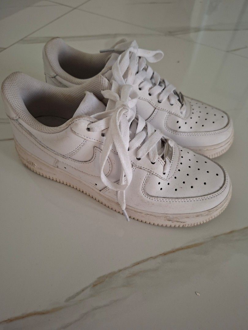 Nike Air Force 1 White Low Sneakers (Category: Sneakers) located in Angeles City. Submitted by miho066_ (Listing ID 1464770940, Image 1). Description: - Authentic Nike Air Force 1 Low top sneakers in classic white - Iconic chunky silhouette with breathable perforated toe box - Premium white leather upper with matching laces and silver AF1 lace dubraes - Durable rubber sole with solid traction - Condition: Regular wear with minor creasing and dust