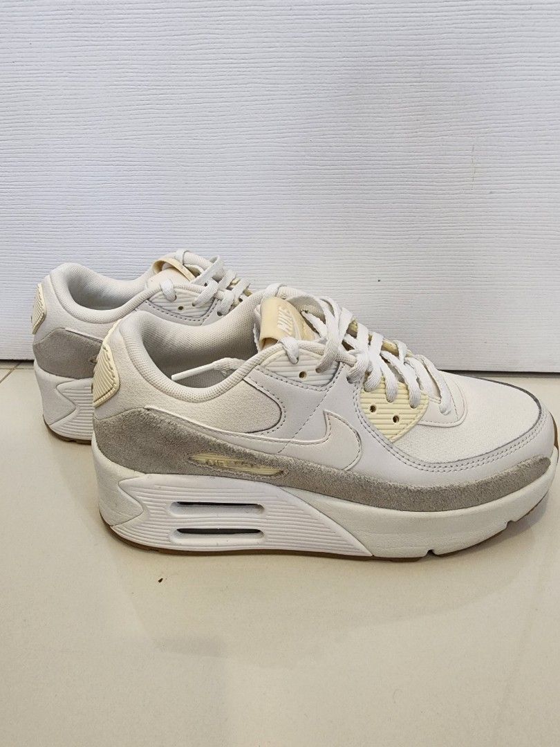 Nike Air Max 90 LV8 Size 7 (Category: Sneakers) located in Quezon City. Submitted by pinkyshang (Listing ID 1464837166, Image 2). Description: - Brand/Model: Nike Air Max 90 LV8 Size 7 - Colorway: Clean White and Cream - Materials: Classic leather and suede upper with gum rubber waffle outsole - Features: Visible Air unit in the heel for comfort and great grip - Condition: Overall clean uppers, strong tread on soles, and minor fading on the Nike 