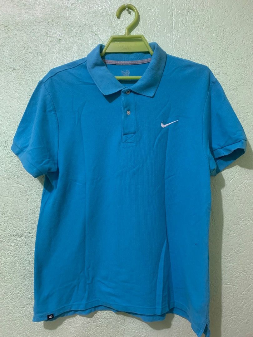 Nike Blue Polo Shirt (Category: Tshirts & Polo Shirts ) located in Daraga. Submitted by ryrilim (Listing ID 1464928125, Image 1). Description: - Brand: Nike - Color: Bright blue - Material: 100% cotton (comfortable everyday wear) - Design: Classic collar, two-button placket, embroidered white Nike swoosh on chest - Details: Small black tag near bottom hem, inner collar size tag - Origin: Made in Vietnam - Condition: Excellent basic wardrobe stapl