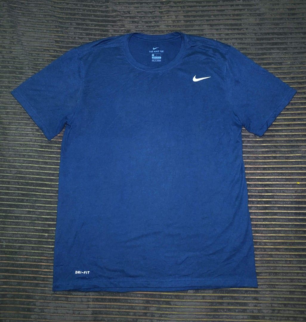 Nike Dri-FIT Blue T-Shirt Size L (Category: Activewear) located in Manila. Submitted by norathrifted (Listing ID 1464795437, Image 1). Description: - Brand: Nike Dri-FIT - Size: Large - Color: Blue with white swoosh logo and hem text - Material: 100% breathable polyester (Made in Nicaragua) - Style: Classic crewneck, ideal for gym or casual wear.
