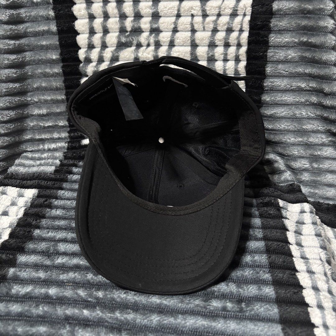 Nike Golf Black Cap with White Swoosh (Category: Caps & Hats) located in Iligan City. Submitted by 9200rsnl (Listing ID 1464798175, Image 3). Description: - Authentic Nike Golf cap in classic black - Features iconic white embroidered swoosh on front and back - Adjustable strap closure for a custom, comfortable fit - Lightweight and breathable fabric ideal for outdoor sports or casual wear - Clean structure with a standard curved brim - Verified N