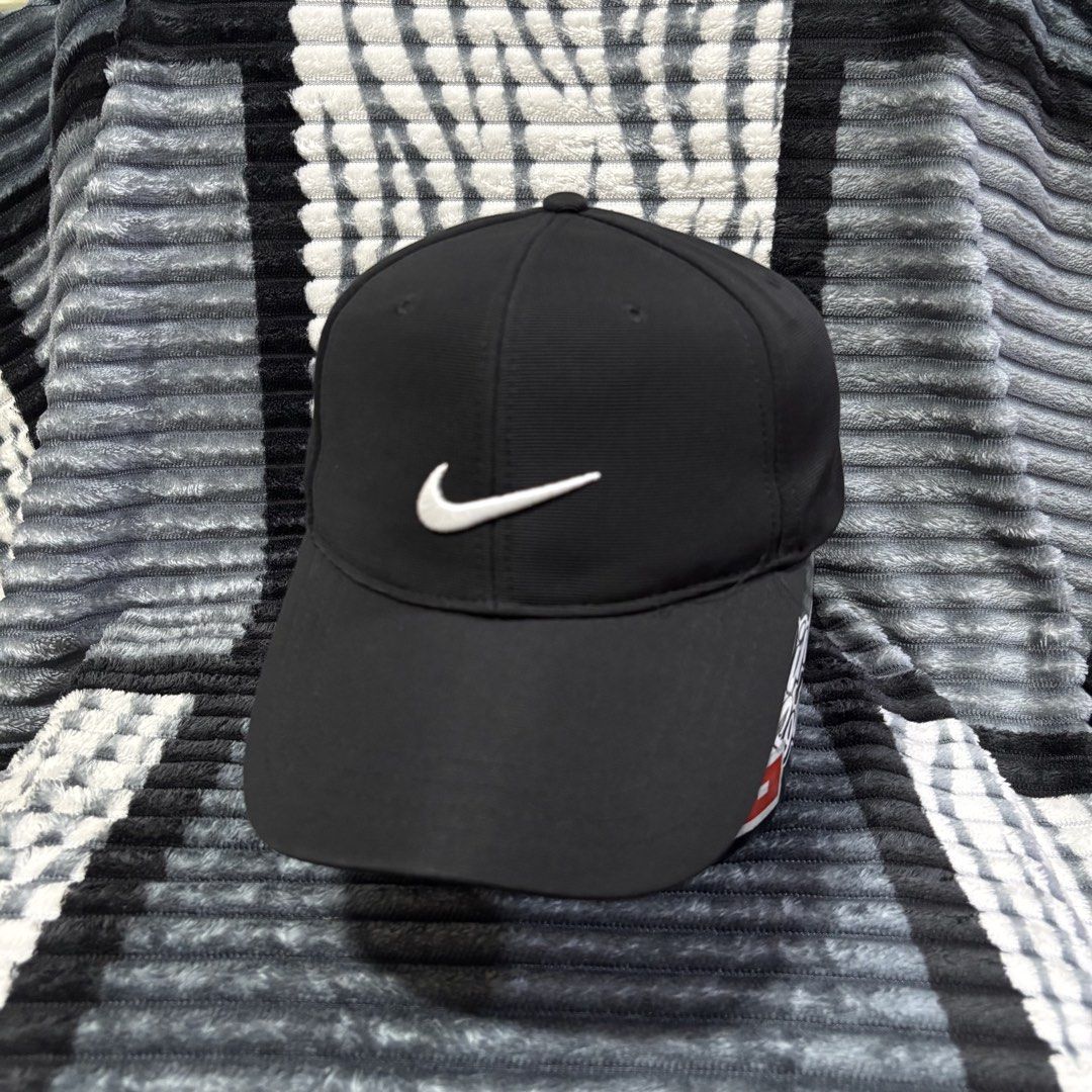 Nike Golf Black Cap with White Swoosh (Category: Caps & Hats) located in Iligan City. Submitted by 9200rsnl (Listing ID 1464798175, Image 1). Description: - Authentic Nike Golf cap in classic black - Features iconic white embroidered swoosh on front and back - Adjustable strap closure for a custom, comfortable fit - Lightweight and breathable fabric ideal for outdoor sports or casual wear - Clean structure with a standard curved brim - Verified N