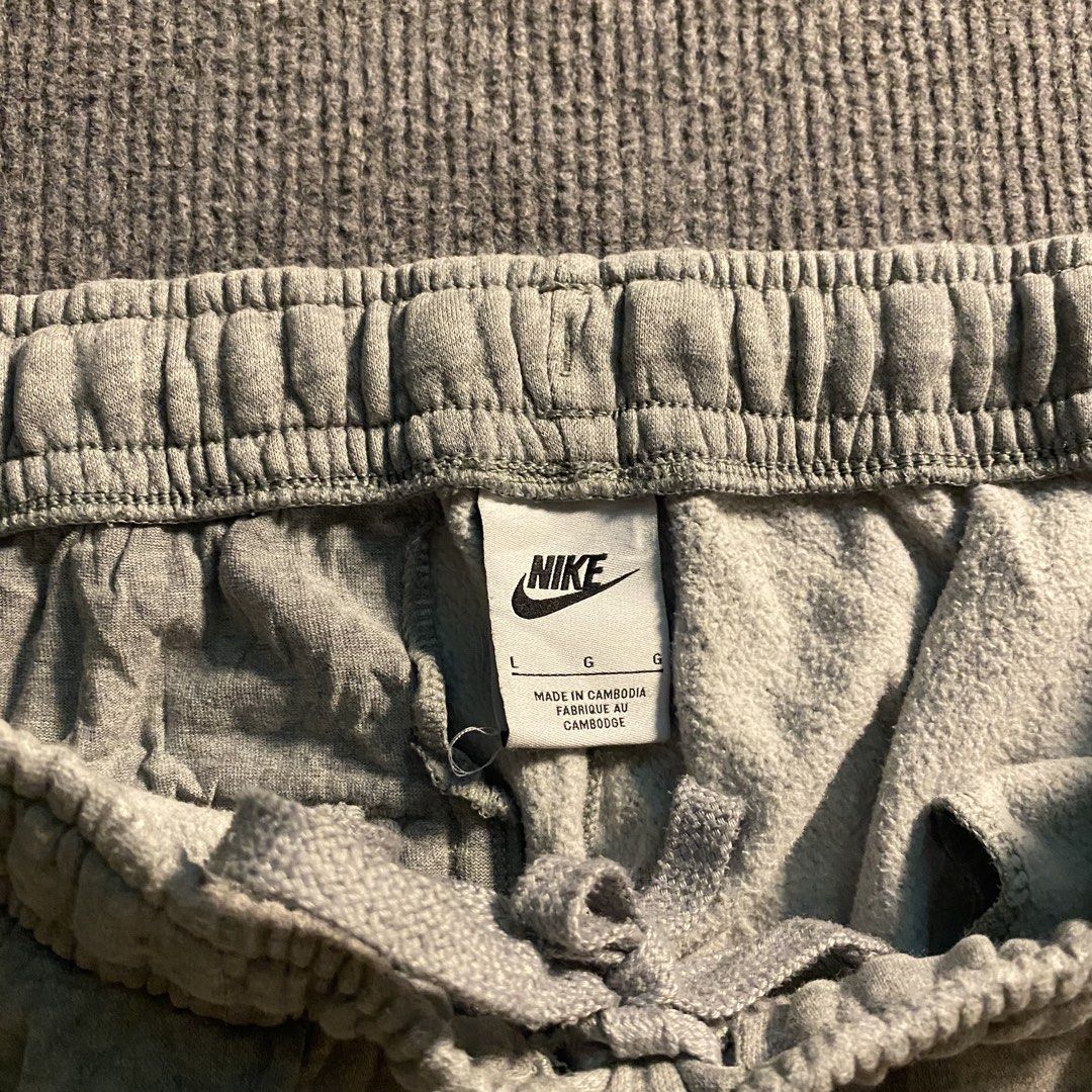 Nike grey sweatpants with logo stack (Category: Joggers) located in Malaybalay. Submitted by mat.loots (Listing ID 1464822816, Image 2). Description: - Brand: Nike - Color: Grey - Size: Large - Design: Multiple stacked Nike logo graphics on the left leg - Material: Thick fleece inside (super warm and cozy) - Fit: Elastic waistband with adjustable drawstring and cuffed ankles - Origin: Made in Cambodia - Condition: Brand new / Excellent quality - 