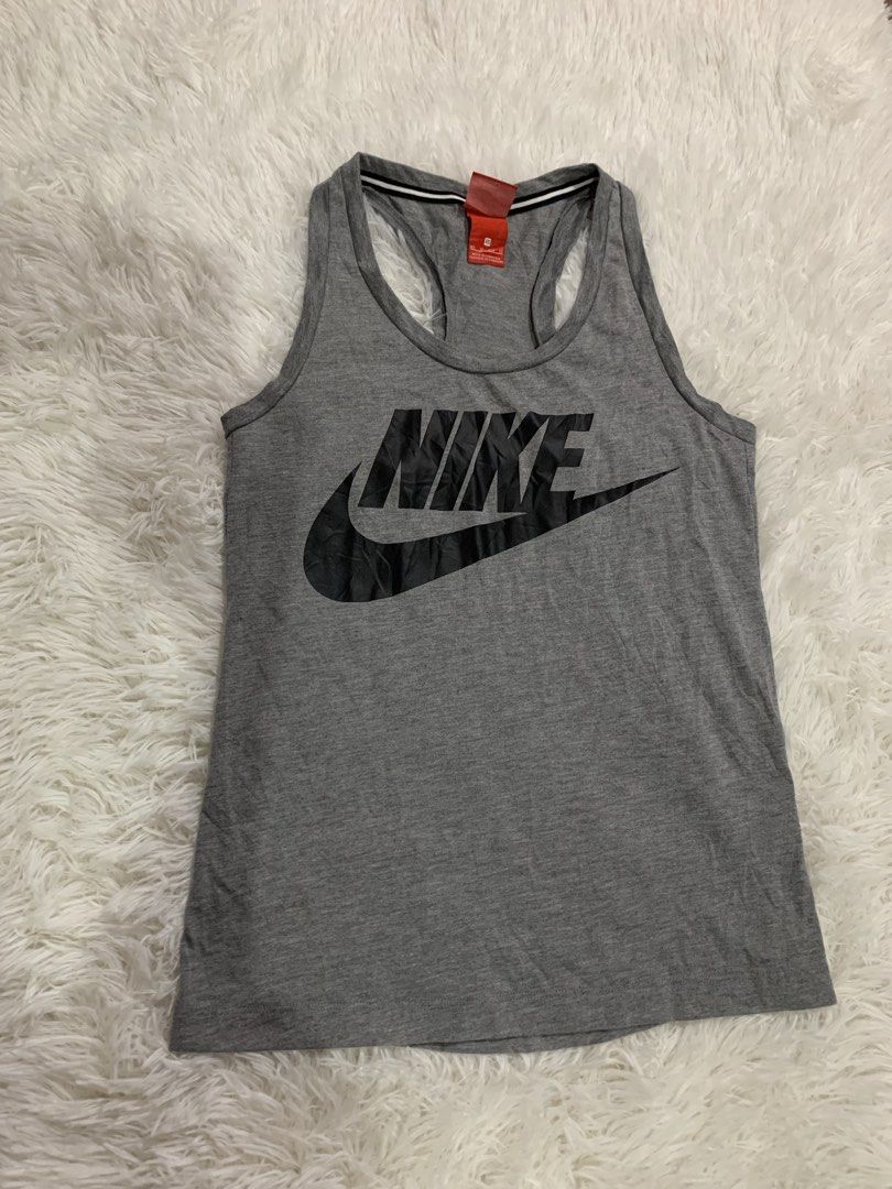 Nike Grey Tank Top Size XS (Category: Sleeveless) located in Iba. Submitted by thriftcoyan (Listing ID 1464886082, Image 1). Description: - Brand: Nike - Style: Racerback tank top - Color: Grey with black front graphic and striped trim - Size: XS (Made in Cambodia) - Material: Soft cotton blend - Condition: Great for workouts or casual everyday wear.