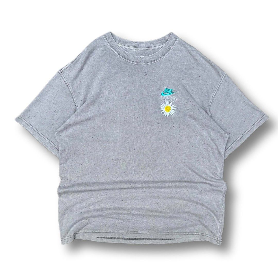 Nike "Have A Nike Day" Daisy Tee (Category: Tshirts & Polo Shirts ) located in Cavite. Submitted by spinfits (Listing ID 1464900137, Image 1). Description: - Brand: Nike - Color: Grey with multi-colored speckles (heavy wash style) - Fit: Relaxed fit, short sleeves - Details: Embroidered teal Nike swoosh and white daisy on the chest - Back Graphic: Bold blue 'HAVE A NIKE DAY' typography on the back hem - Condition: Excellent, ready to wear Size: L
