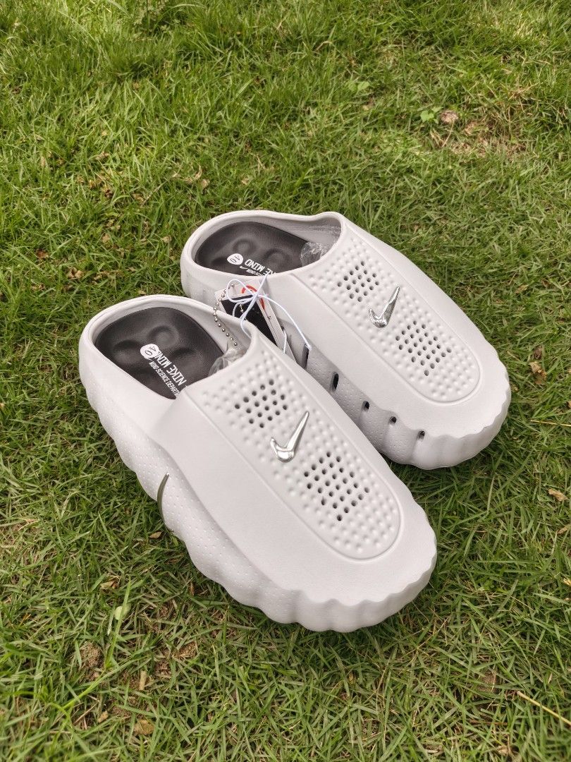 Nike Mind Close (Category: Slippers & Slides) located in Santo Tomas. Submitted by nodaysoffthreads (Listing ID 1464880493, Image 1). Description: - Brand: Nike - Item: Slip-on clogs with ventilation holes - Color: Grey with silver Nike swoosh - Size: EU 40 (marked on black inner sole) - Special Detail: "Mind Science Department" text on inner sole - Condition: Brand new, never worn, straight out of storage - Extras: Original plastic tags still at