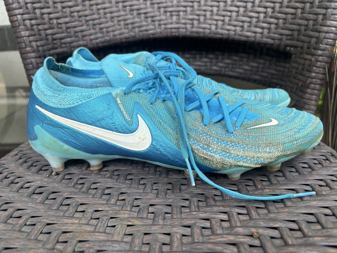 Nike Phantom GX Elite FG Blue Soccer Cleats (Category: Sneakers) located in Manila. Submitted by danikes (Listing ID 1464915978, Image 2). Description: - Model: Nike Phantom GX soccer cleats - Colorway: Blue and turquoise with matching blue laces - Upper: Gripknit texture across the strike zone for better ball control - Outsole: Molded studs designed for firm ground traction - Condition: Minor dirt marks from regular pitch use, still in great pla