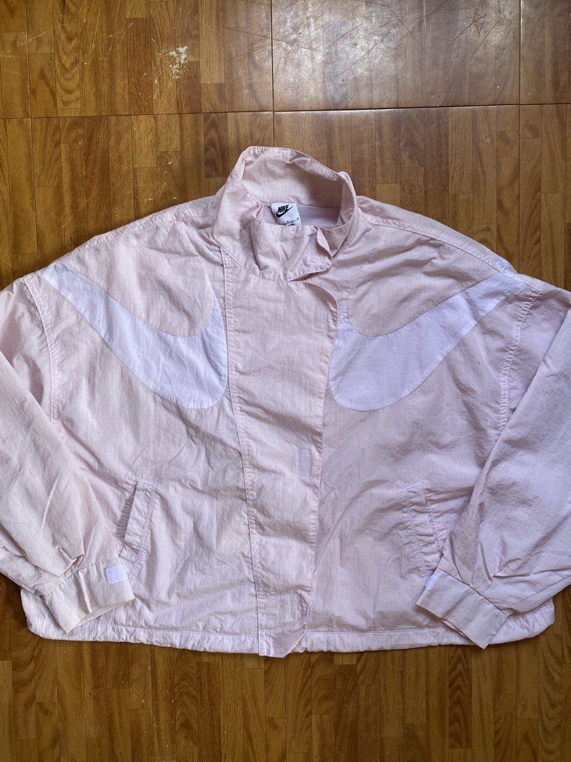 Nike Pink Swoosh Repel Windbreaker Jacket (Category: Coats, Jackets and Outerwear) located in Bulacan. Submitted by trippin_thriftin (Listing ID 1464898822, Image 1). Description: Nike Pink Repel Jacket 29x25 (M on Tag) No issue - Brand: Nike - Item: Pink windbreaker jacket - Size: Medium (Standard fit) - Design: Large swoosh branding across the chest - Details: Stand-up collar with a metal swoosh zipper pull, mesh interior lining, and adjustable