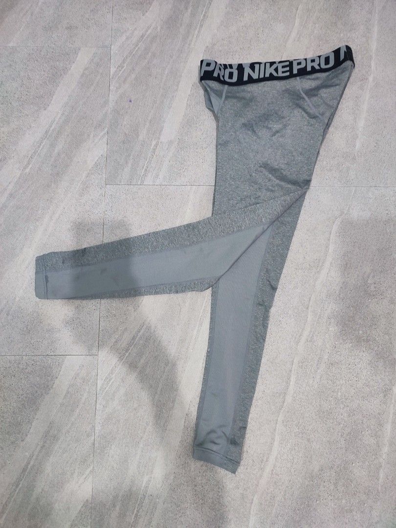 Nike Pro Warm Men's Tights Grey Size S (Category: Activewear) located in Taguig. Submitted by thriftzzzy (Listing ID 1464882473, Image 2). Description: - Brand: Nike Pro - Item: Warm Tights / Leggings - Color: Grey - Size: Small (S) - Thick elastic waistband with bold branding - Breathable mesh panels at crotch and thighs for ventilation - Subtle Nike swoosh logo on lower left leg - Ideal for gym workouts, running, or cold weather layering - Cond