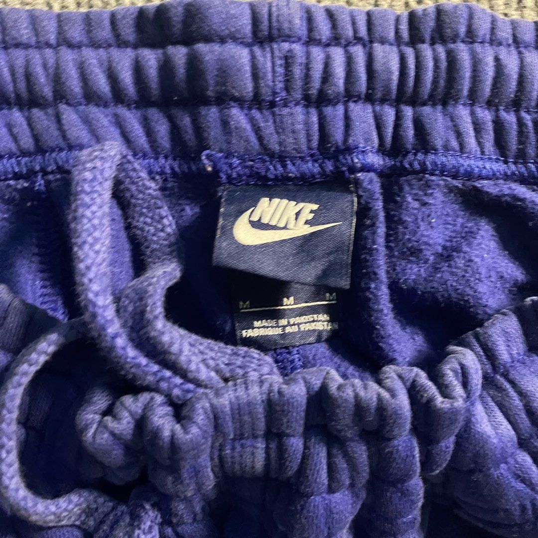 Nike Purple Sweatpants Drawstring Waist Size M (Category: Joggers) located in Malaybalay. Submitted by mat.loots (Listing ID 1464822741, Image 2). Description: - Brand: Nike - Color: Purple with yellow logo - Size: Medium (M) - Fit: Adjustable drawstring waist, elasticated waistband and cuffs - Details: Printed yellow Nike text logo on left thigh - Interior: Cozy fleece material for maximum comfort - Origin: Made in Pakistan - Condition/Use: Perf