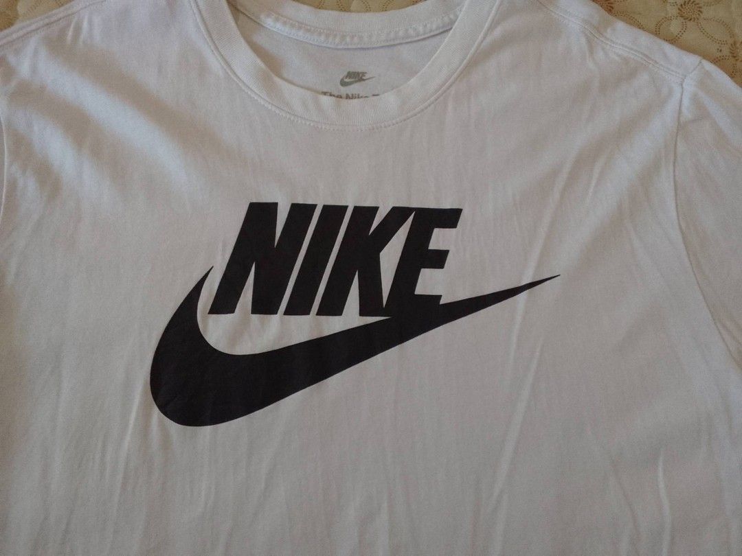Nike White T-Shirt XL (Category: Tshirts & Polo Shirts ) located in Zamboanga. Submitted by nurbya898048 (Listing ID 1464925390, Image 2). Description: Classic white Nike tee featuring the iconic black logo across the chest. Size XXL, regular fit with short sleeves and a crew neck. Made in Vietnam from 100 percent cotton. Clean fabric, clear print graphics, and tag labels intact. Great staple piece for casual everyday wear. Size fit to extra larg