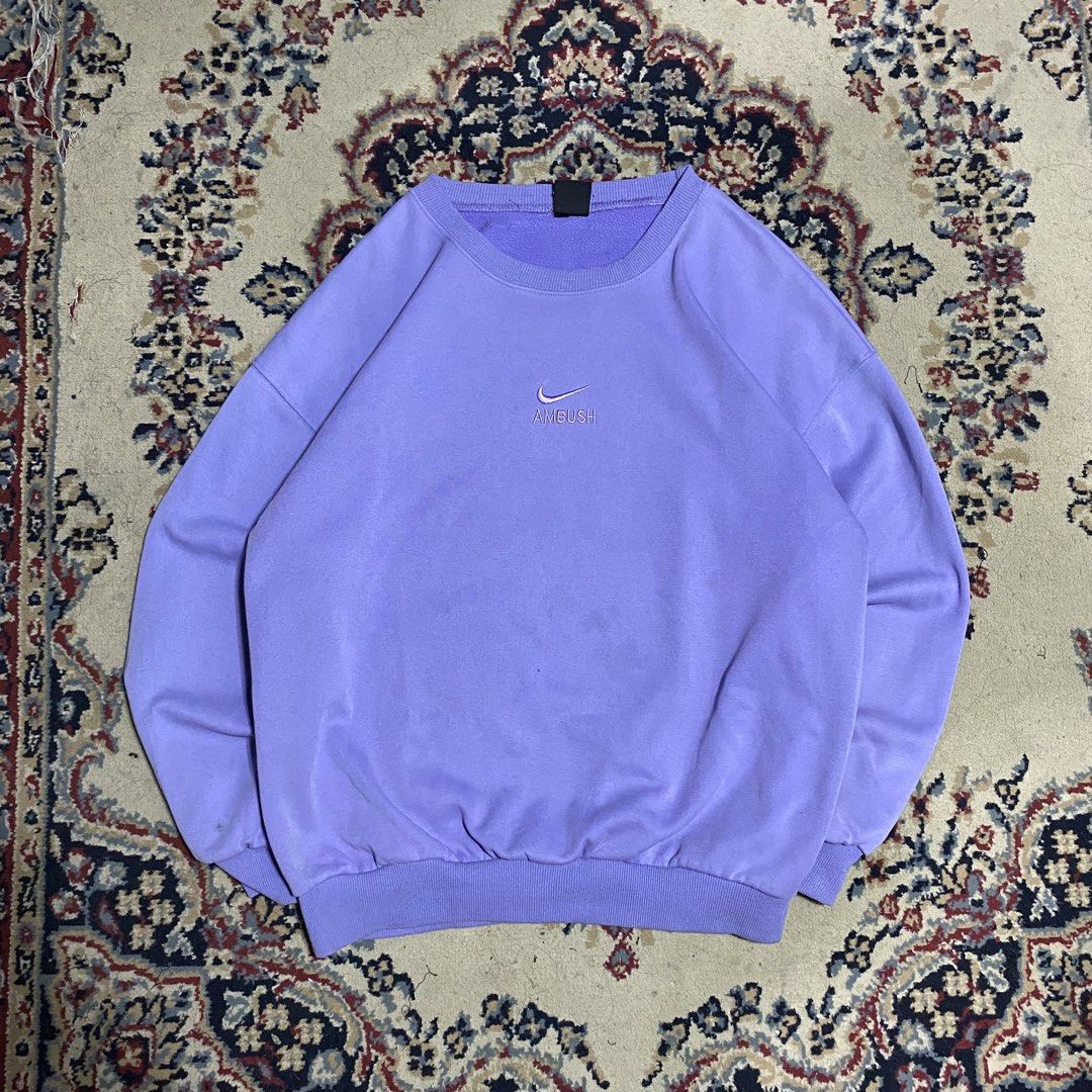 Nike x Ambush Purple Sweatshirt (Category: Coats, Jackets and Outerwear) located in Manila. Submitted by thrifturfit_star (Listing ID 1464941399, Image 1). Description: - Brand: Nike x Ambush collaboration - Color: Light purple - Design: Embroidered Nike Swoosh and Ambush lettering on the chest - Details: Classic crewneck collar with ribbed cuffs and hem - Style: Clean look, versatile for daily streetwear fits - Condition: Brand new / Excellent (