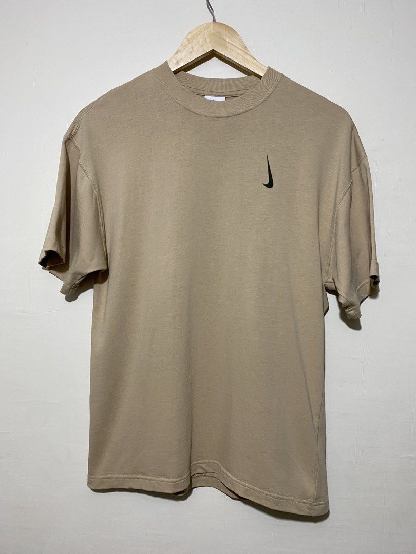 NIKE X (BILLIE EILISH), T-shirt (Category: Tshirts & Polo Shirts ) located in Cavite. Submitted by jc_thrift95 (Listing ID 1464832587, Image 1). Description: - a Nike x Billie Eilish S/S Tee in Mushroom featuring an earthy tan-brown tone and a rotated vertical Swoosh logo on the chest. - L-26.5 inch - W-19 inch - Color rate9/10 - See pictures details for dimes..