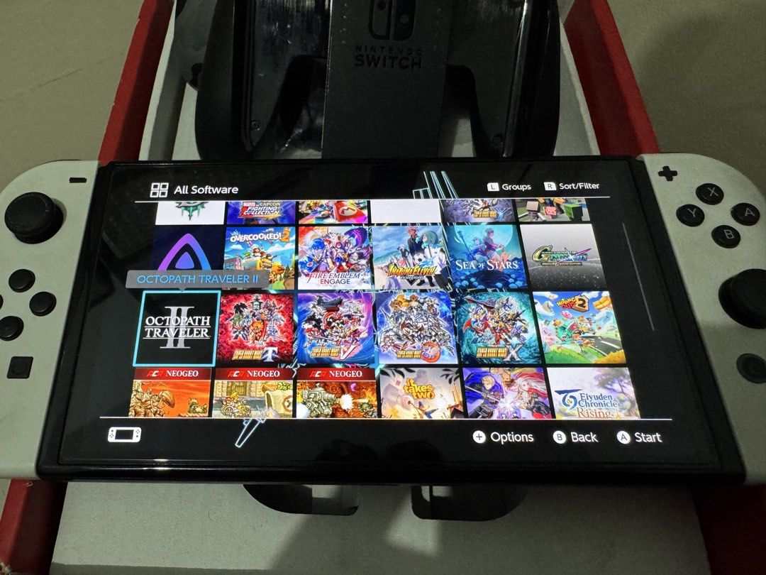 Nintendo Switch OLED 256GB JailBreak (Category: Nintendo) located in Manila. Submitted by airag22 (Listing ID 1464862824, Image 3). Description: - Nintendo Switch OLED (White color) with clean screen and attached joy-cons - SanDisk 256GB MicroSD card in the back slot (Original) - Includes Surge camo pro controller for enhanced gaming - Comes with a stylish gray felt carrying case - Original box included, 100% ready to play - Over 200+ games via D