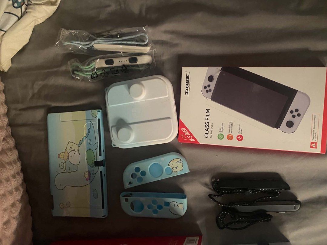 Nintendo Switch OLED Model Bundle with Games and Accessories (Category: Nintendo) located in Taguig. Submitted by jessybelle67486 (Listing ID 1464824745, Image 3). Description: - Nintendo Switch OLED White Console with original box - Complete standard accessories: White dock, Joy-Cons, grip, and charger - 4 Physical Games: Luigi's Mansion 2 HD, Overcooked Special Edition, Nintendo Switch Sports, and Crayon Shin-chan - 1 Online Games: Just Dance -