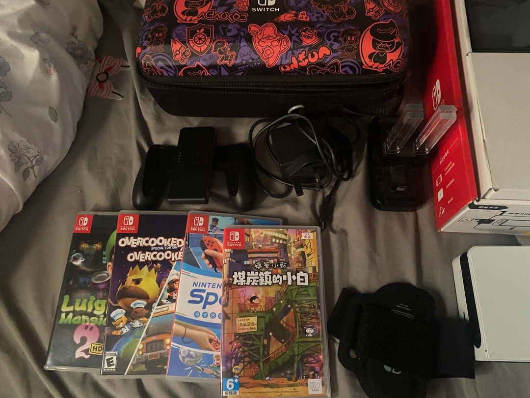 Nintendo Switch OLED Model Bundle with Games and Accessories (Category: Nintendo) located in Taguig. Submitted by jessybelle67486 (Listing ID 1464824745, Image 2). Description: - Nintendo Switch OLED White Console with original box - Complete standard accessories: White dock, Joy-Cons, grip, and charger - 4 Physical Games: Luigi's Mansion 2 HD, Overcooked Special Edition, Nintendo Switch Sports, and Crayon Shin-chan - 1 Online Games: Just Dance -