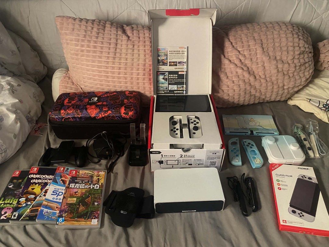Nintendo Switch OLED Model Bundle with Games and Accessories (Category: Nintendo) located in Taguig. Submitted by jessybelle67486 (Listing ID 1464824745, Image 1). Description: - Nintendo Switch OLED White Console with original box - Complete standard accessories: White dock, Joy-Cons, grip, and charger - 4 Physical Games: Luigi's Mansion 2 HD, Overcooked Special Edition, Nintendo Switch Sports, and Crayon Shin-chan - 1 Online Games: Just Dance -