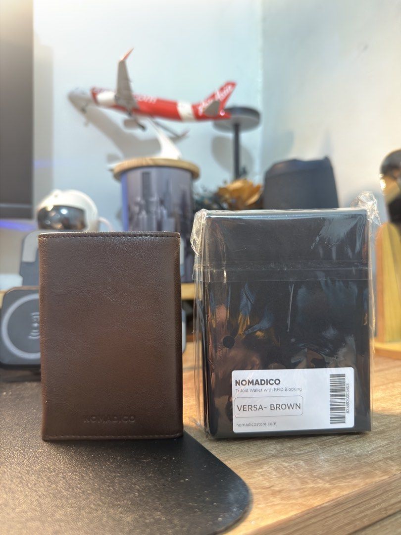 Nomadico Versa Trifold Wallet — BROWN (Category: Wallets & Card Holders) located in Manila. Submitted by t13thstreet_og (Listing ID 1464872647, Image 2). Description: NOMADICO VERSA TRIFOLD WALLET - BROWN reason for selling: duplicate purchase. Already got my own as a gift. item details: • brandnew and sealed • never been used/opened • the one in the first photo is my personal wallet, not the one inside the box. Design details: • Holds 1-12 cards