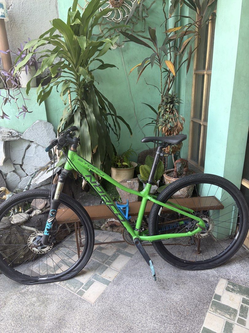 Norco Storm Green Mountain Bike (Category: Bicycles) located in Manila. Submitted by giann_30 (Listing ID 1464897748, Image 1). Description: - Green Norco Storm frame with black handlebars and saddle - Fox front suspension fork/shocks - Front and rear disc brakes installed - Blue bottle cage and standard flat pedals included - Flaws: Chain has some oxidation and the front tire is completely flat/needs repair - Flat tires.
