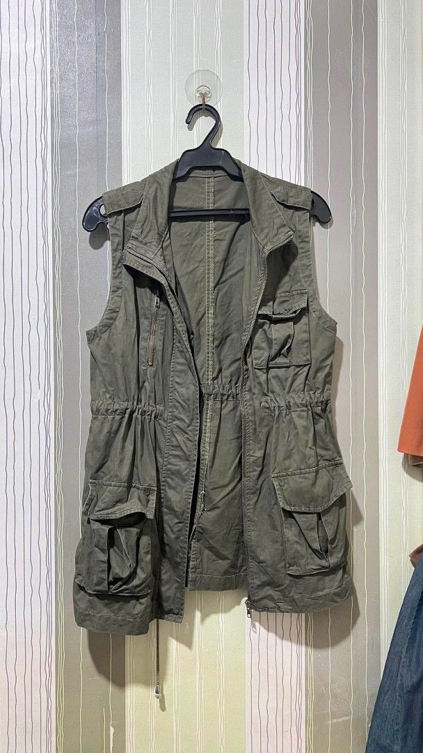 Olive Green Vest with Multiple Pockets (Category: Coats, Jackets and Outerwear) located in Manila. Submitted by rmr-preloved (Listing ID 1464873674, Image 3). Description: - Color: Olive green - Style: Sleeveless vest with zip-up front - Storage: Multiple front cargo pockets - Fit: Adjustable drawstring waist - Material: Lightweight fabric - Best for: Casual layering Size Medium to Large.