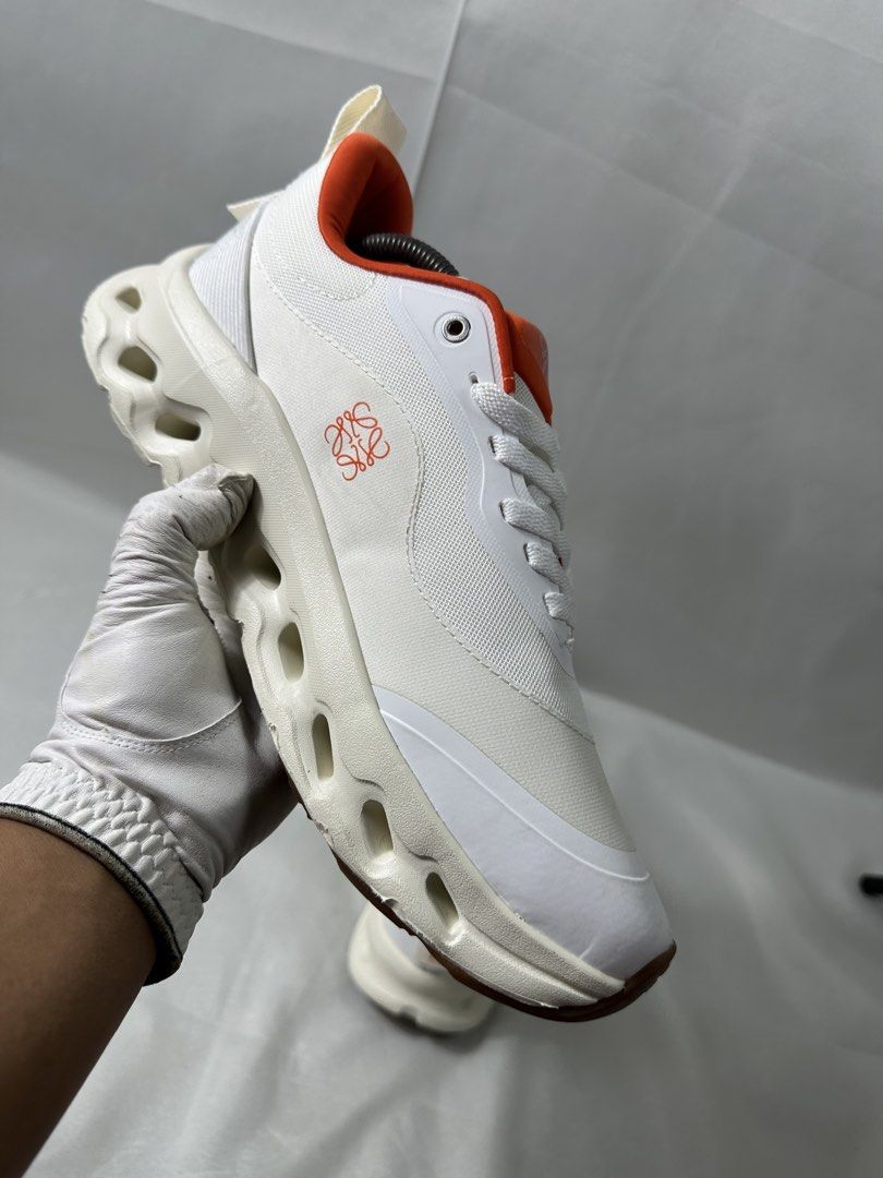On Cloud x Loewe Cloudtilt 2 Sneakers (Category: Casual Shoes) located in Cabanglasan. Submitted by thefashiongarage.co (Listing ID 1464780775, Image 2). Description: Title - On Cloud x Loewe Model/Name - Cloudtilt 2 Size on Tag - 11USM Conditiion - Excellent Condition with no heel drag - Minimal Stain only - Washable Dimension (WxLxH) - Category- Running/Casual Fitting - Trye to size Made in - Vietnam Material - Color - White with Orange colorwa