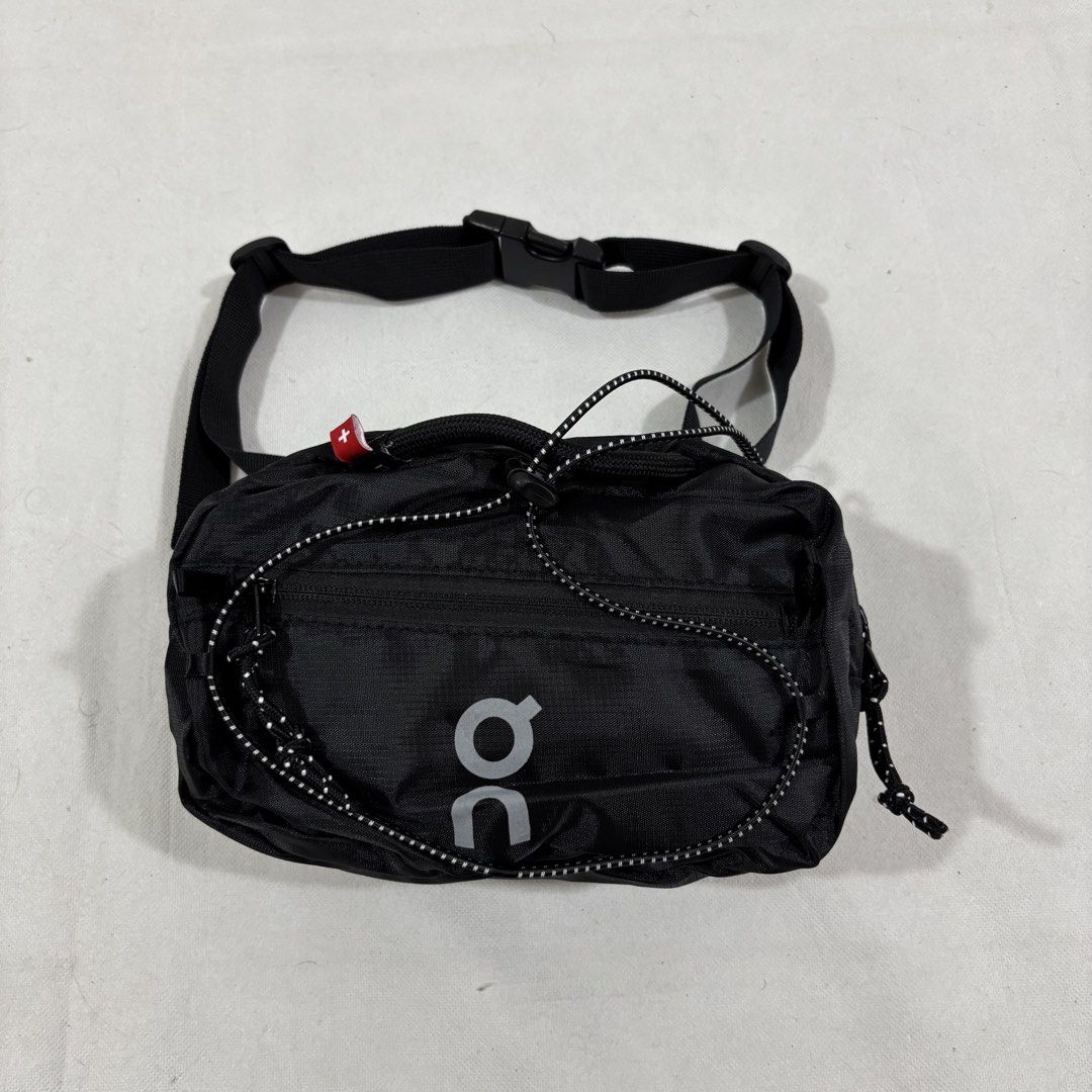 On Running Waterproof Fanny Pack Black (Category: Belt bags, Clutches and Pouches) located in Cavite. Submitted by itsayaaa (Listing ID 1464836892, Image 1). Description: - Brand: On Running - Color: Sleek black with reflective logo for visibility - Material: Lightweight and water-resistant - Storage: Spacious main compartment with interior zipper pocket - Exterior: Convenient front bungee cord system for extra gear - Fit: Adjustable waist strap 