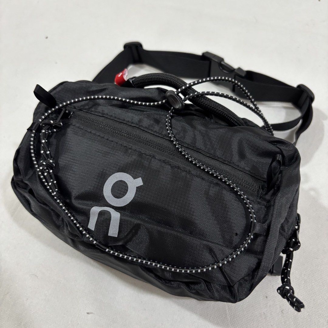 On Running Waterproof Fanny Pack Black (Category: Belt bags, Clutches and Pouches) located in Cavite. Submitted by itsayaaa (Listing ID 1464836892, Image 2). Description: - Brand: On Running - Color: Sleek black with reflective logo for visibility - Material: Lightweight and water-resistant - Storage: Spacious main compartment with interior zipper pocket - Exterior: Convenient front bungee cord system for extra gear - Fit: Adjustable waist strap 