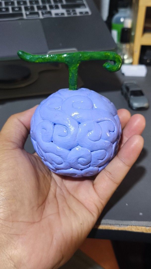Ope Ope no Mi Devil Fruit Replica Anime Figure (Category: Figurines & Statues) located in Manila. Submitted by keenpenguin-a5e72e (Listing ID 1464940165, Image 3). Description: - Handcrafted One Piece Ope Ope no Mi Devil Fruit figure - Sculpted from clay and meticulously painted by hand - Light blue body with iconic curly pattern and bright green stem - Compact, palm-sized design - Perfect for anime collectors and desk displays.