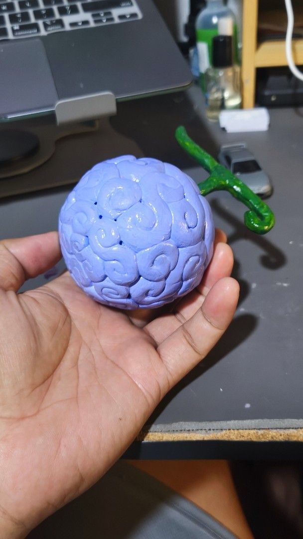 Ope Ope no Mi Devil Fruit Replica Anime Figure (Category: Figurines & Statues) located in Manila. Submitted by keenpenguin-a5e72e (Listing ID 1464940165, Image 2). Description: - Handcrafted One Piece Ope Ope no Mi Devil Fruit figure - Sculpted from clay and meticulously painted by hand - Light blue body with iconic curly pattern and bright green stem - Compact, palm-sized design - Perfect for anime collectors and desk displays.