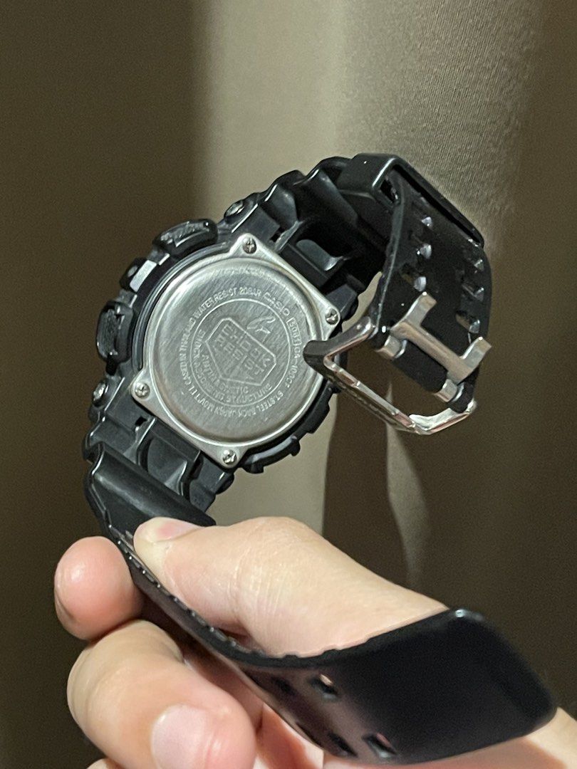 Original G-Shock GA-100 (Category: Men's Watches) located in Manila. Submitted by le016392 (Listing ID 1464771787, Image 3). Description: - Model: Casio G-Shock GA-100 (Classic Black) - Condition: Working battery, accurate timekeeping, minor scuffs on the resin strap - Features: Analog & digital dual time, shock resistant, water resistant up to 20 bar - Inclusion: Original hexagonal metal storage tin - Perfect for daily wear and tough sports acti
