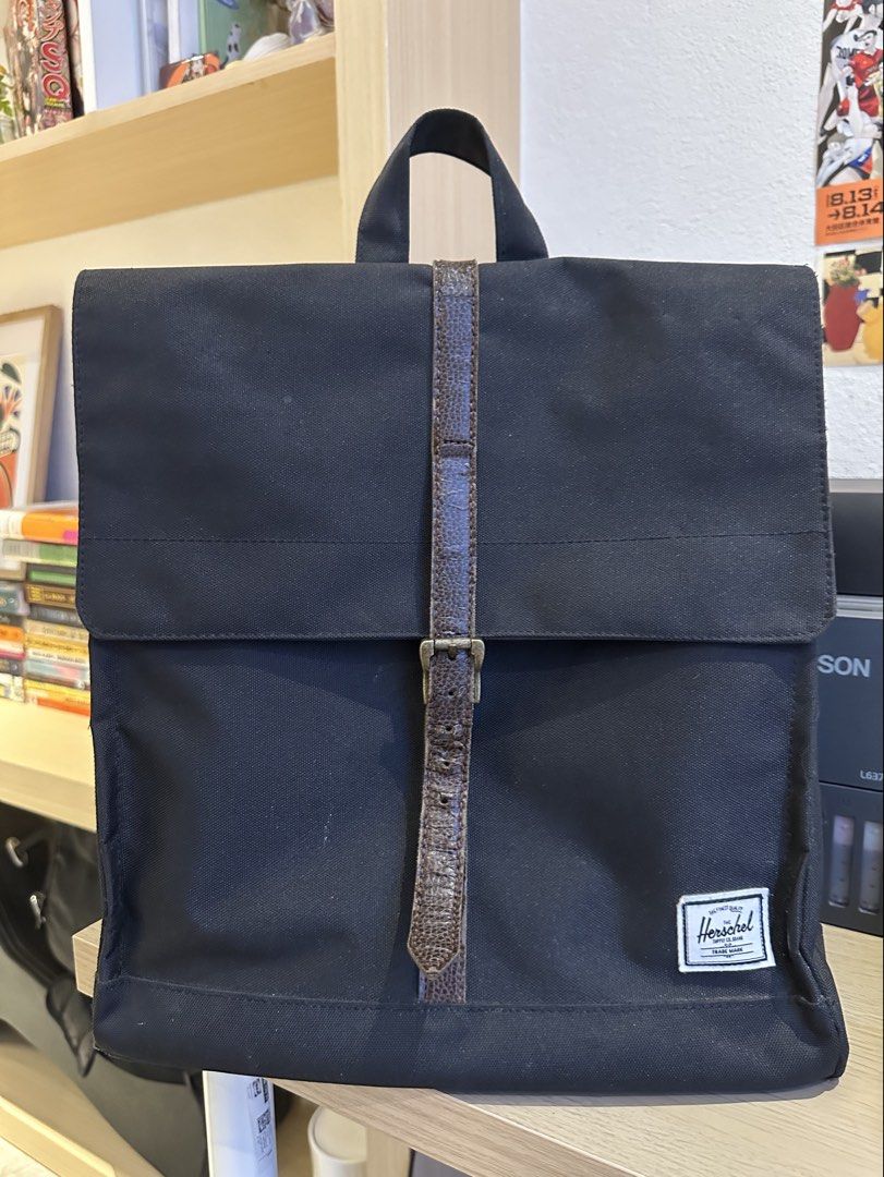 ORIGINAL Herschel Supply Co. Backpack - Black (Category: Backpacks) located in Quezon City. Submitted by mars_f (Listing ID 1464859718, Image 1). Description: Main flaw is the front strap/clasp since the leather has started peeling. Otherwise, all good. - Classic Design - Front zip pocket - Spacious main compartment - Signature red and white stripe lining - Adjustable shoulder straps.