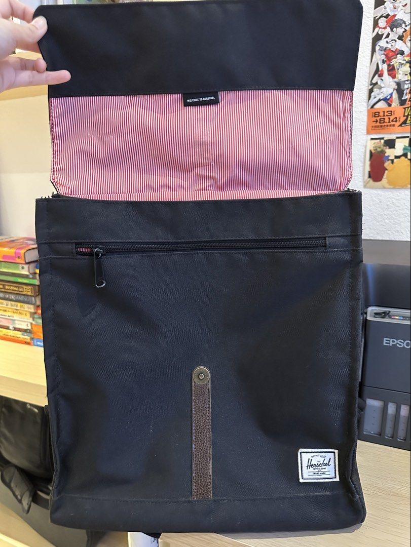 ORIGINAL Herschel Supply Co. Backpack - Black (Category: Backpacks) located in Quezon City. Submitted by mars_f (Listing ID 1464859718, Image 3). Description: Main flaw is the front strap/clasp since the leather has started peeling. Otherwise, all good. - Classic Design - Front zip pocket - Spacious main compartment - Signature red and white stripe lining - Adjustable shoulder straps.