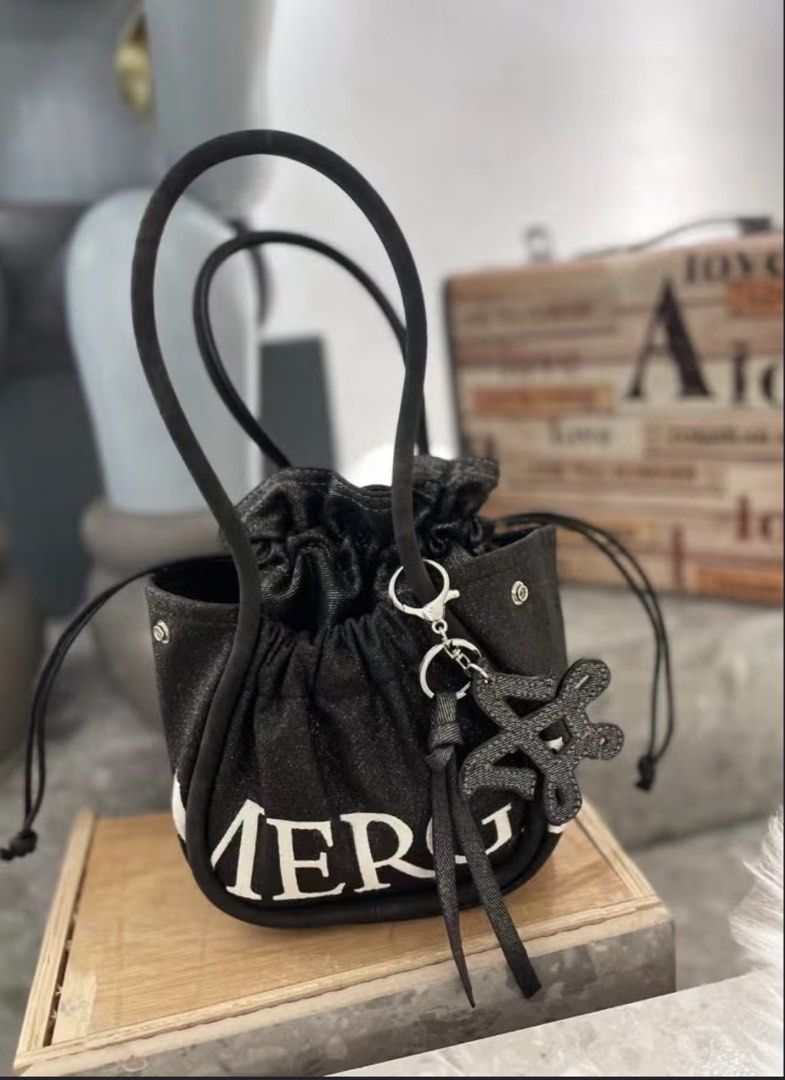 Original Merge bag (small size) (Category: Shoulder Bags) located in Manila. Submitted by vengonflo (Listing ID 1464927718, Image 2). Description: - Brand: SUPER SUN - Material: Soft denim fabric - Design: Pink contrast piping and handles with bold 'MERC' lettering on the front - Closure: Convenient drawstring top - Size: Compact and perfect for everyday use - Extra: Includes a matching shaped keychain charm attached to the handle - A popular bra