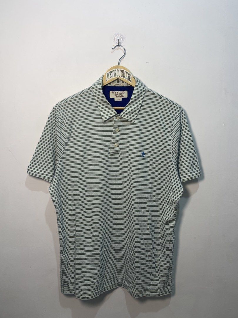 Original Penguin Striped Polo Shirt Size L (Category: Tshirts & Polo Shirts ) located in Davao. Submitted by legitseller1111 (Listing ID 1464771102, Image 1). Description: - Brand: Original Penguin by Munsingwear - Size: Large - Color: White with blue and green horizontal stripes - Fit: Classic fit with standard collar and 3-button placket - Details: Blue contrast inner collar and signature blue embroidered penguin logo on the chest - Origin: Mad