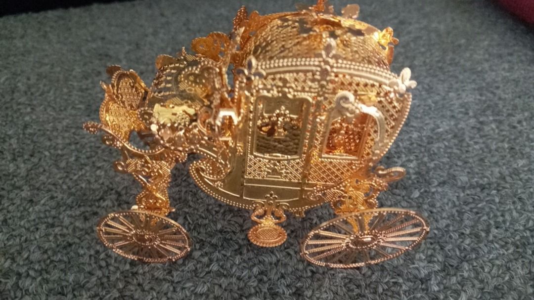Ornate Gold Carriage Display Ornament (Category: Vintage Collectibles) located in Paranaque City. Submitted by zuprocsejon38604 (Listing ID 1462400409, Image 3). Description: - Beautifully detailed gold carriage ornament. - Features intricate scrollwork and design. - Adds a regal charm to shelves or tables. - Ideal for collectors or as a unique gift..