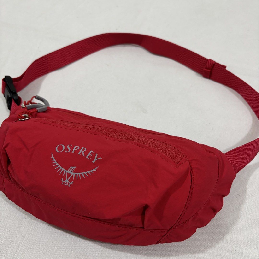 Osprey Red Waist Pack Bum Bag (Category: Belt bags, Clutches and Pouches) located in Cavite. Submitted by itsayaaa (Listing ID 1464836886, Image 2). Description: - Brand: Osprey - Color: Bright red with grey pull loops - Material: Durable and lightweight nylon - Compartments: Handy front zippered pocket and wide-opening main compartment - Fit: Adjustable strap with secure black plastic buckle - Use: Practical everyday carry for keys, phone, and w