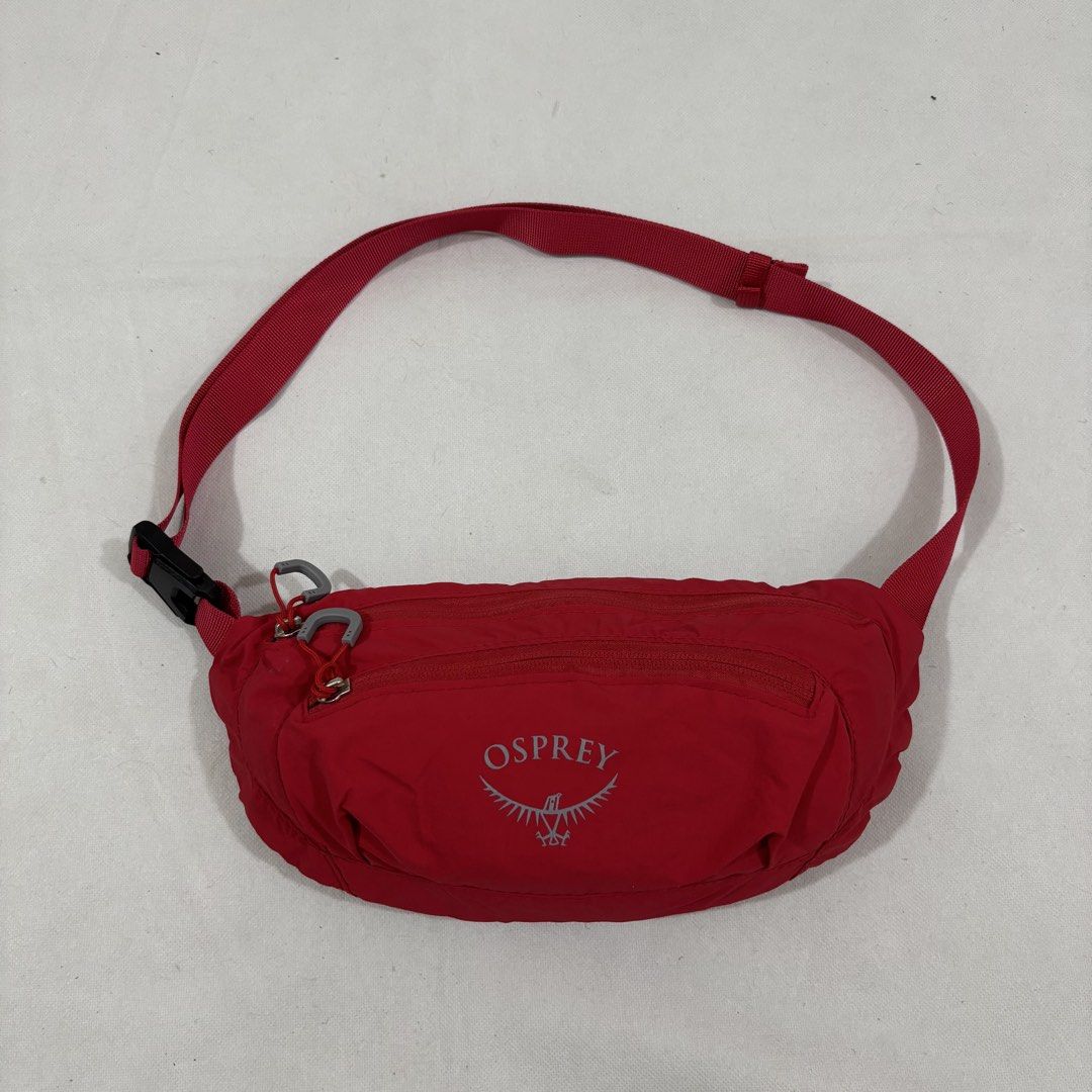 Osprey Red Waist Pack Bum Bag (Category: Belt bags, Clutches and Pouches) located in Cavite. Submitted by itsayaaa (Listing ID 1464836886, Image 1). Description: - Brand: Osprey - Color: Bright red with grey pull loops - Material: Durable and lightweight nylon - Compartments: Handy front zippered pocket and wide-opening main compartment - Fit: Adjustable strap with secure black plastic buckle - Use: Practical everyday carry for keys, phone, and w