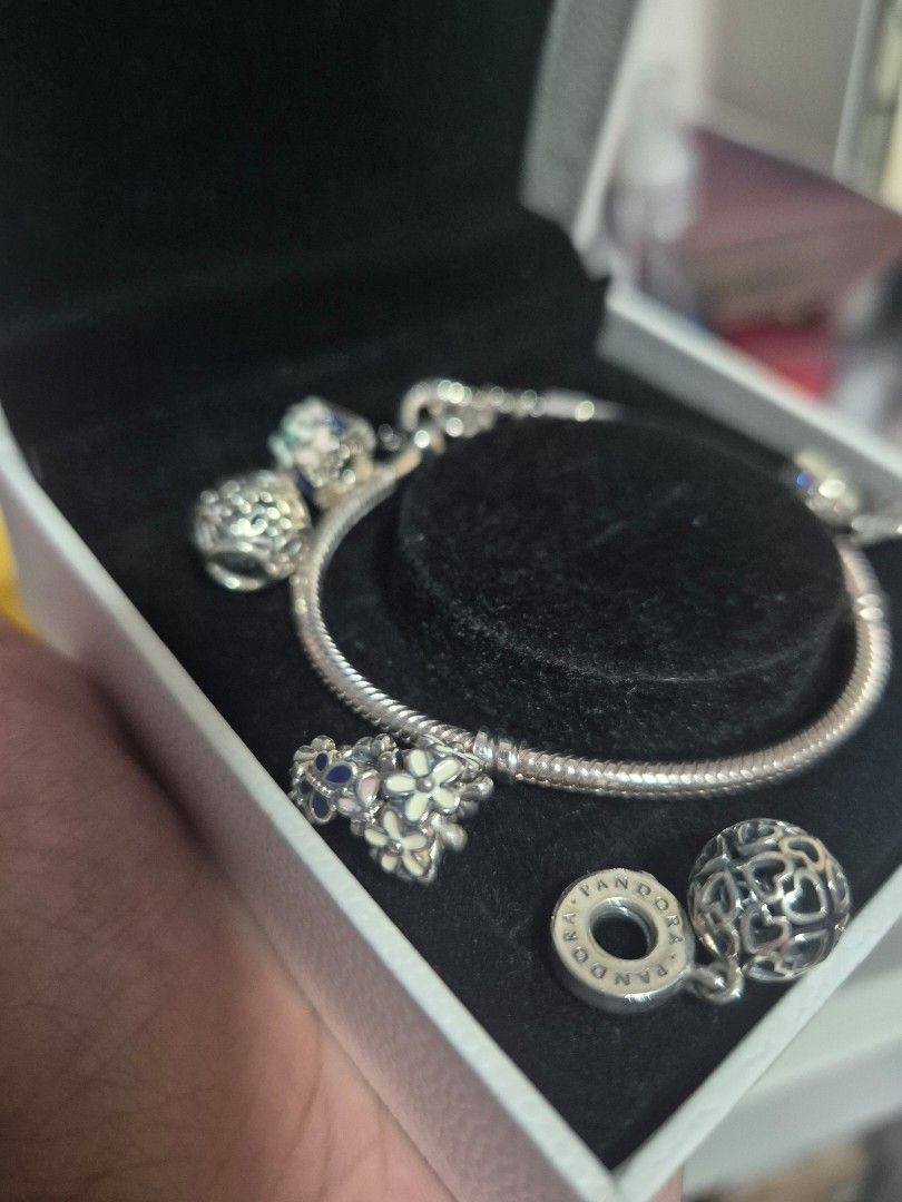 Pandora Charm Bracelet with Multiple Charms in Box (Category: Bracelets) located in Cainta. Submitted by mintandcinnamon (Listing ID 1464887454, Image 3). Description: - Authentic Pandora snake chain bracelet set 19cm - Includes original white storage box with velvet-lined slot - with 2 dangling charms, 2 regular charms, 2 spacers and 1 spacer/lock.